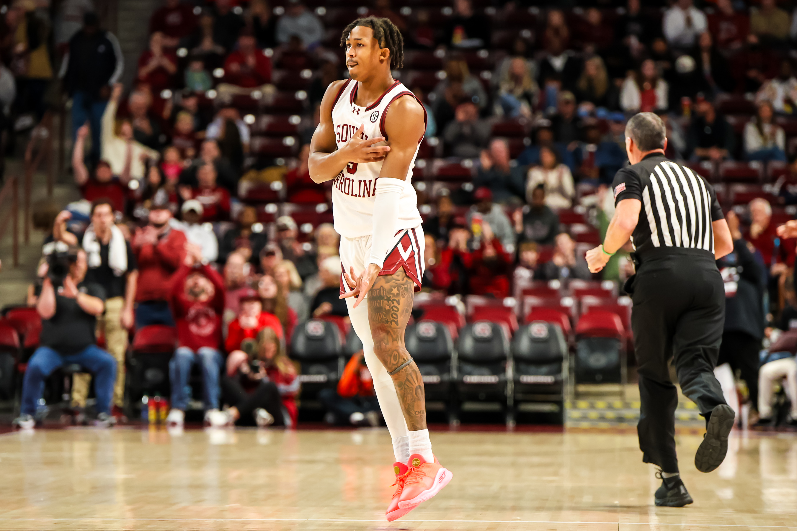 Meechie Johnson celebrates a three-point basket against the Florida A&M Rattlers